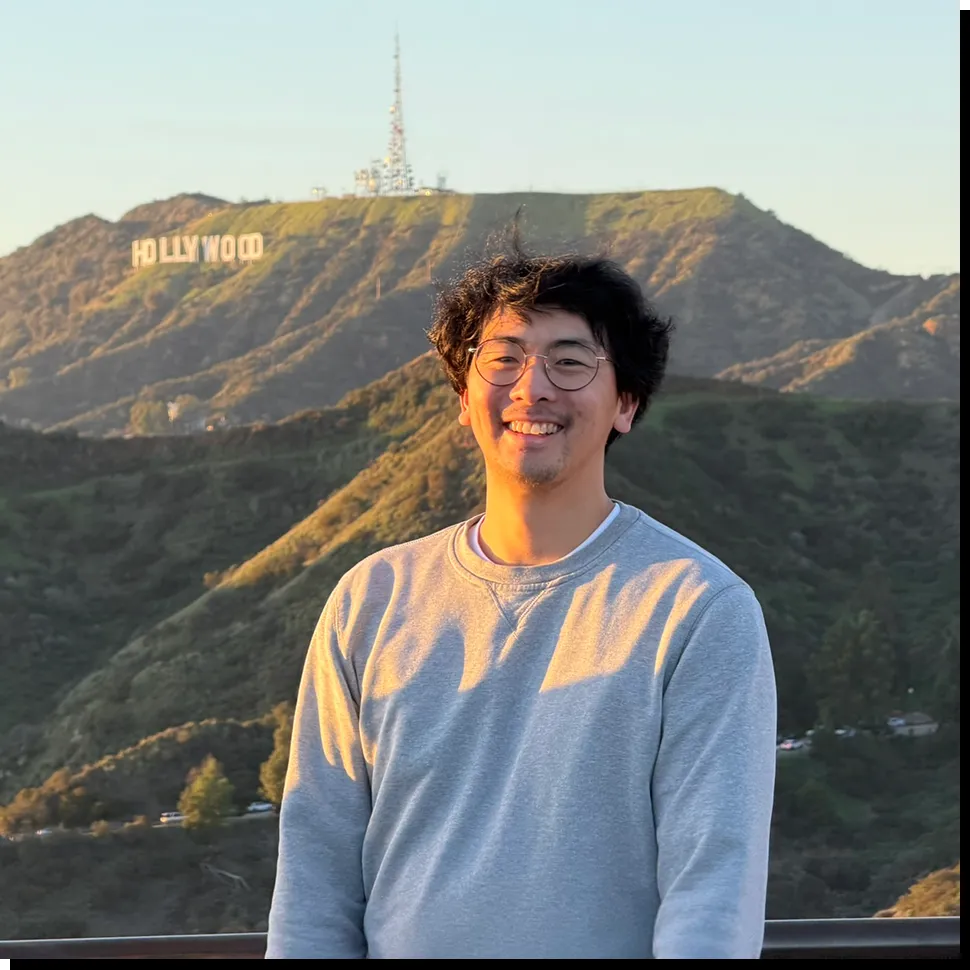 Darren smiling in front of the Hollywood sign